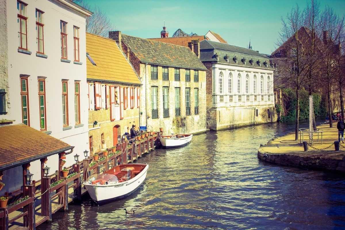 Historic houses along a canal with small boats