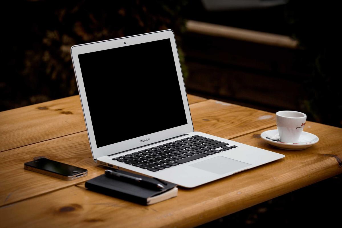 An open laptop on a tidy white desk